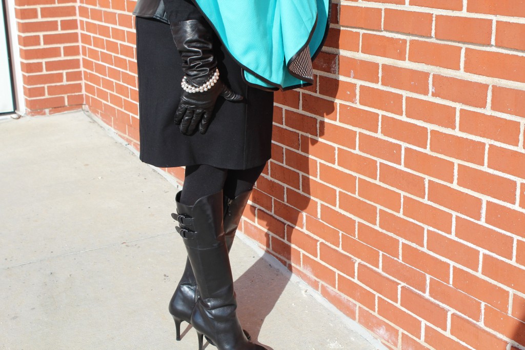 Wearing Coach Asymmetrical cape, Portolano elbow-length leather gloves, random black knot skirt, Spanx tights, Cole Haan Air Georgina Tall Black Boots with Tiffany ball necklace worn as bracelet.