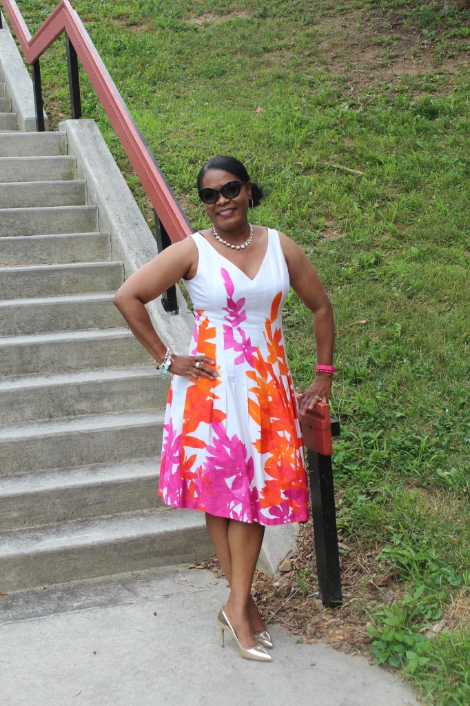 Wearing old fit and flare dress purchased at T. J. Maxx, gold glitter bottom Mui Mui gold pumps with Prada sunnies