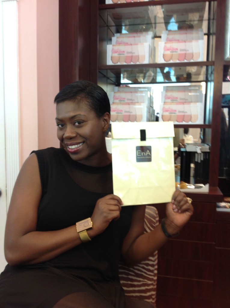 Stylist Toi Sweeney holding her EnA Fine Jewelry gift certificate for volunteering to be our make-over model.