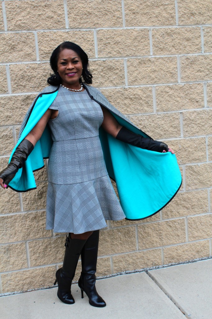 Wearing Last year's Coach asymmetrical cape, J. Crew glen plaid cap-sleeve dress, J. Crew necklace, Vince Camuto leather fingerless gloves with Cole Haan Georgia Tall black boots