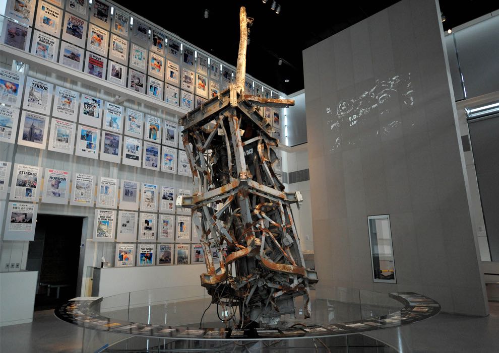 The mangled TV antenna from the World Trade Center with a wall of the days front pages from around the world at Newseum in Washington, D.C.