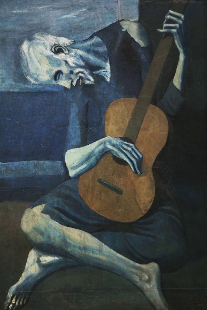 The Old Guitarist, 1903 from the Art INstitute of Chicago. During Pablo Picasso's Blue Period. During this time he painted somber works, essentially monochromatic paintings in shades of blue and blue-green