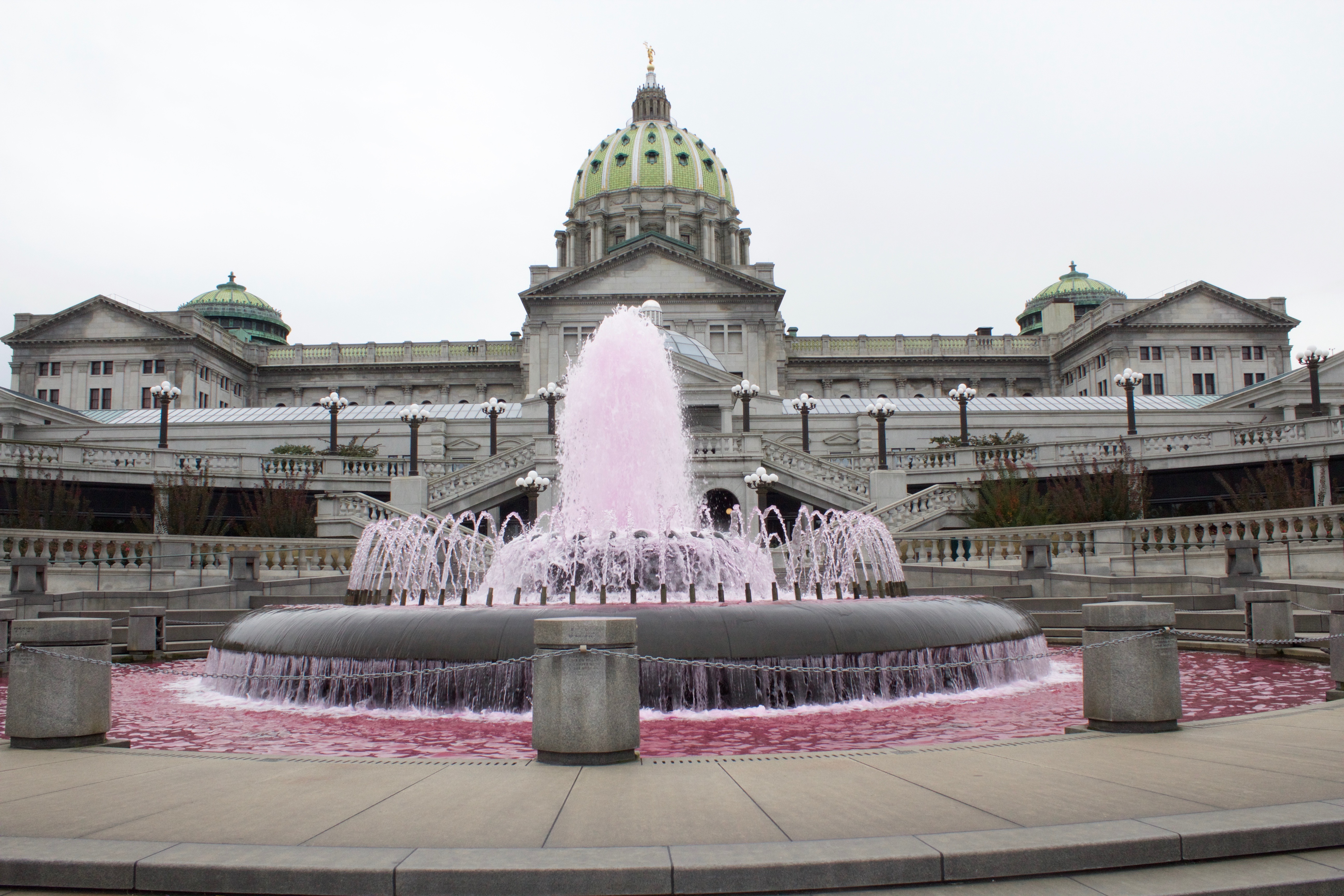 The PA State Capital Complex Fountain fowing with pink water for Annual Breast Cancer Awareness