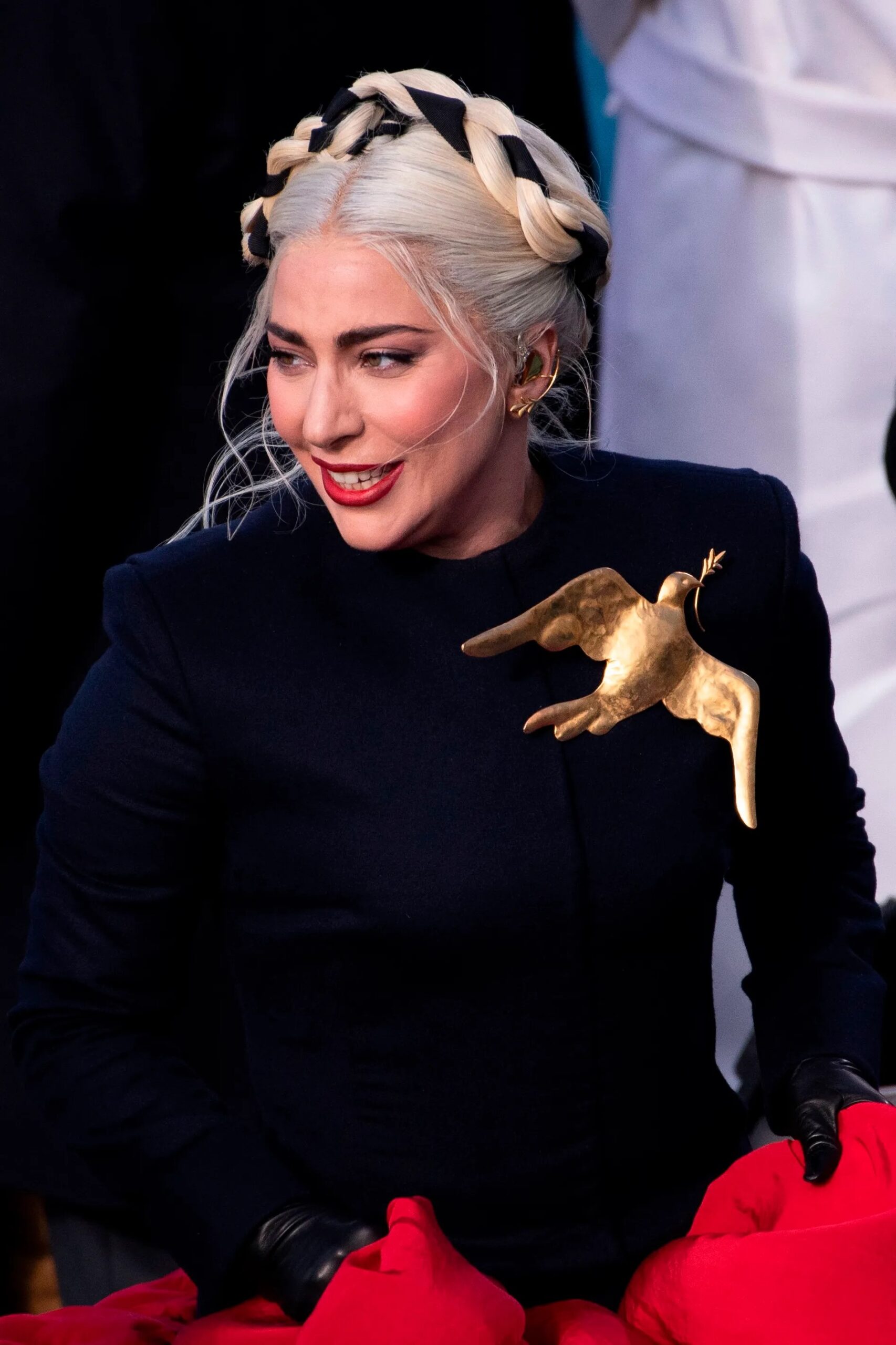 Caroline Brehman Image of Lady Gaga at Biden Inauguration wearing Schiaparelli Brooch designed by creative director Daniel Roseberry