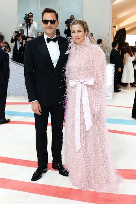Former tennis starts Roger Federer and wife Mirka wearing light pink feathers at the 2023 Met Gala