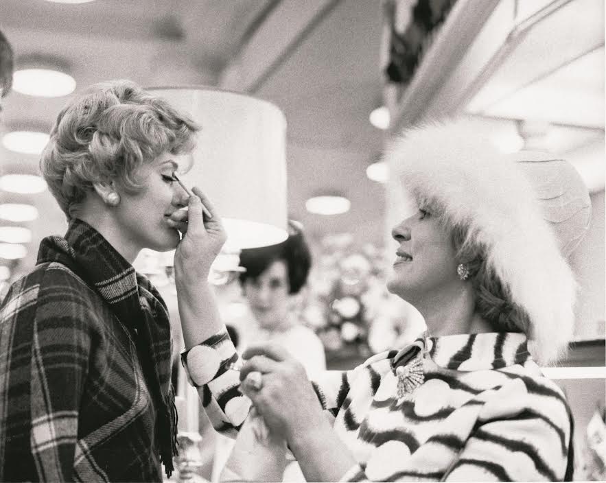 1968 photo of Estée Lauder making over a customer in a St. Louis department store.