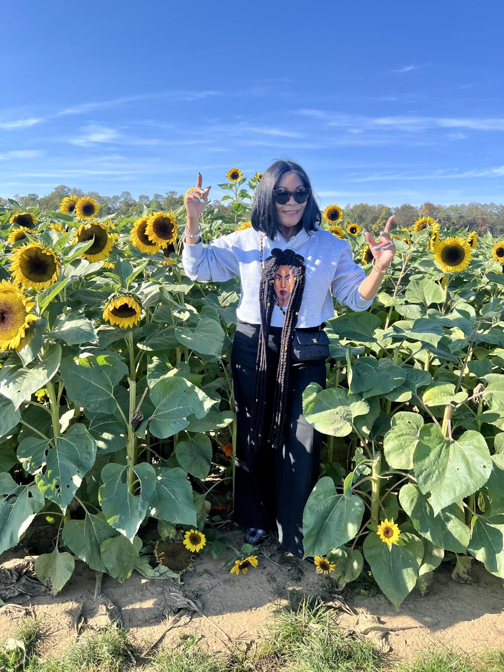 Kimberly Goldson Limited-Edition Amirah Bantu Knot Cropped Hoodies, me standng in the fall flowers at Holland Ridge Farm in New Jersey